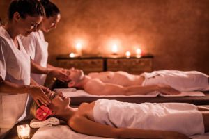 Relaxed couple having a facial massage treatment at the spa.